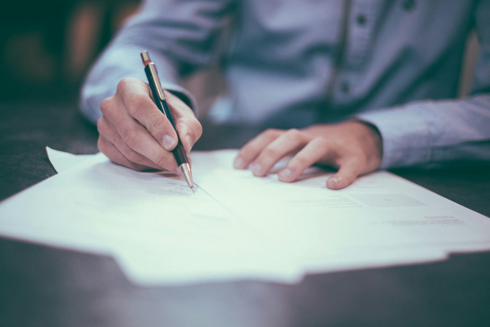 Insurance professional reviewing policy documents at a desk